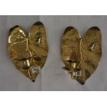 A pair of Arts and Crafts brass wall candle sconces, with leaf design, back plated with raised