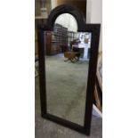 A carved mahogany stained mirror, with bevelled glass