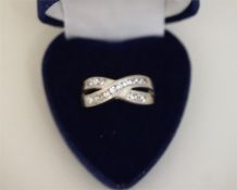 A Ladies Silver Crossover Dress Ring, size R, also with a gem set ring, (2)