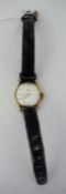 A Ladies Gold Backed Omega Wristwatch, with champagne dial bearing arabic and baton numerals, on a