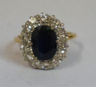 A Large Ladies Sapphire & Diamond 18ct Gold Dress Ring, the centre sapphire set with 14 brilliant