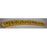 A Carved Ivory Tusk, probably Oriental, decorated with figures and pagodas, 35.5cm long