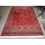 A Kashmir Machine Made Rug, Decorated with multiple rows of small Geometric medallions, with further