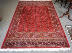 A Kashmir Machine Made Rug, Decorated with multiple rows of small Geometric medallions, with further