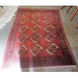 A Hamadan Machine Made Rug, Decorated with five rows of three Geometric medallions on a red