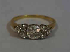 A Ladies Diamond 18ct Gold Ring, the centre stone approximately one carat, with three smaller