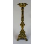 A Victorian Brass Pugin Style Candle Stand, with moulded mask decoration, raised on ball and claw