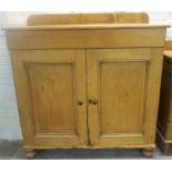 A Victorian Pine Farmhouse Kitchen Cupboard, with two panelled doors enclosing a shelved interior,