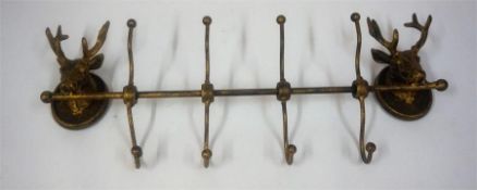 A Metal Wall Mounting Hat & Coat Rack, decorated with two stags head surmounts, 50cm wide