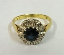A Ladies Sapphire & Diamond Cluster Ring, the centre stone Sapphire is surrounded with small