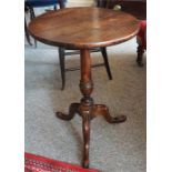 A 19th Century Mahogany Tripod Table, the circular top raised on turned column and tripod base, 63cm