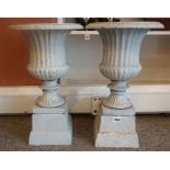 A Pair Of Painted Metal Campagna Urns, raised on square stand, 49cm high, (2)