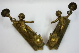 A Pair Of Antique Gilt Metal Wall Mounting Gas Lights, Modelled as a putti child holding aloft