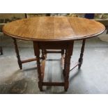An Oak Gateleg Table, with D ends, raised on turned legs, 72cm high, 92cm long, 120cm wide