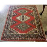 A Kashmir Machine Made Rug, Decorated with three Geometric panels to the centre, with a floral