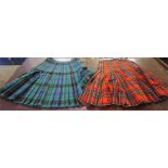 Two Dress Kilts, one sized for a 30-32 inch waist, the other in the clan Stewart tartan, 28 inch