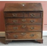 A Georgian Oak Writing Bureau, with hinged fall front enclosing fitted drawers and pigeon holes,