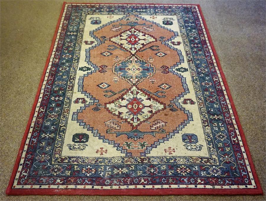 A Kashmir Machine Made Rug, Decorated with three Geometric panels to the centre, further Geometric