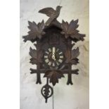 A Black Forest Style Cuckoo Clock, with cuckoo surmount above dial with Roman numerals, with two