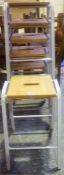 A Set Of Six Stacking Stools, with wooden seat raised on a painted metal frame, 63cm high, 38cm