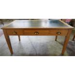 An Edwardian Ash Writing Table, with a green skiver to the top above three drawers, raised on