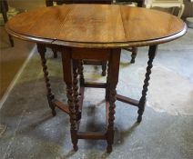 A Small Oak Gateleg Table, raised on barley twist legs,71cm high, 81cm long, 90cm wide
