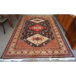 A Kashmir Machine Made Rug, Decorated with three large Geometric medallions to the centre, with