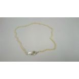 A Graduated Cultured Pearl Necklace, with gem set clasp, 25cm long Condition report Clasp is in a