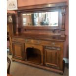 An Arts & Crafts Mahogany Mirrorback Sideboard, The large mirorback is raised on reeded columns