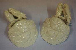 A Pair Of Victorian Wall Pockets By Royal Worcester, with a surmount decorated with parrots