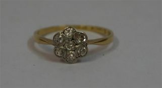 A Ladies Diamond Flower Head 18ct Gold Cluster Ring, size O