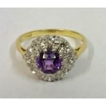 A Ladies 18ct Gold Dress Ring, set with a centre Amethyst surrounded by small Diamonds, ring size O