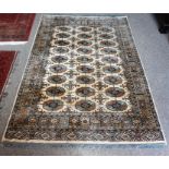 A Kashmir Machine Made Rug, Decorated with nine rows of three geometric panels, on a cream and beige