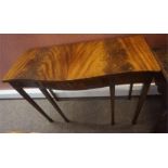 A Reproduction Mahogany Serpentine Console Table, with a single drawer, raised on tapered legs