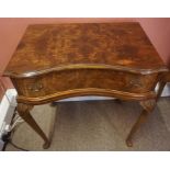 A Walnut Serpentine Side Table, circa mid 20th century, with a single drawer, raised on cabriole