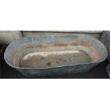 A Galvanised Tin Bath, with carry handles, 34cm high, 122cm wide