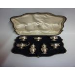 A Silver Seven Piece Condiment Set, Hallmarks for London, Comprising of four matching cellars,