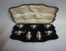 A Silver Seven Piece Condiment Set, Hallmarks for London, Comprising of four matching cellars,