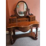 A Victorian Mahogany Dressing Table, with swing mirror above fitted drawers and large drawer, with