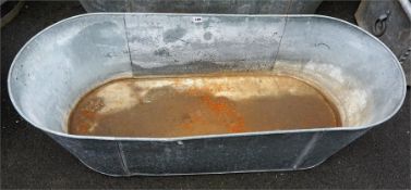 A Galvanised Tin Bath, with carry handles, 34cm high, 122cm wide