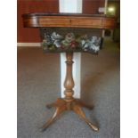 A Victorian Birch & Ebony Strung Sewing Table, with a hinged top above a beadwork cover, raised on a