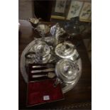 A Quantity Of Silver Plated Wares, to include a Georgian style coffee pot, glass claret jug with a