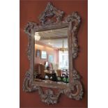A Modern French Style Wall Mirror, with moulded floral and scroll decoration, 139cm high, 82cm wide