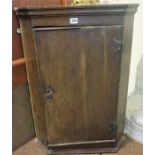 A George III Oak Hanging Corner Cupboard, with a panelled door enclosing shelved interior, 81cm