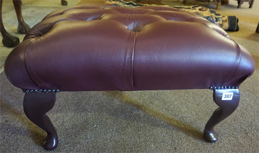 A Modern Leather Buttoned Footstool, wine coloured, raised on cabriole legs, 32cm high