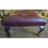 A Modern Leather Buttoned Footstool, wine coloured, raised on cabriole legs, 32cm high