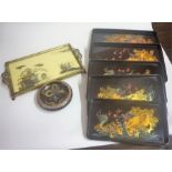 A Set Of Five Oriental Laquered Graduated Trays, Decorated with painted panels of dragons, largest