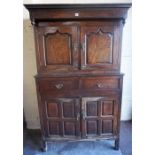 A George III Oak Housekeepers Cupboard, with two panelled doors above two drawers and two further