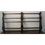 An Ercol Wall Hanging Plate Rack, 62cm high, 105cm wide.