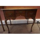 A George III Style Oak Lowboy, circa 19th century, with three fitted drawers, raised on cabriole